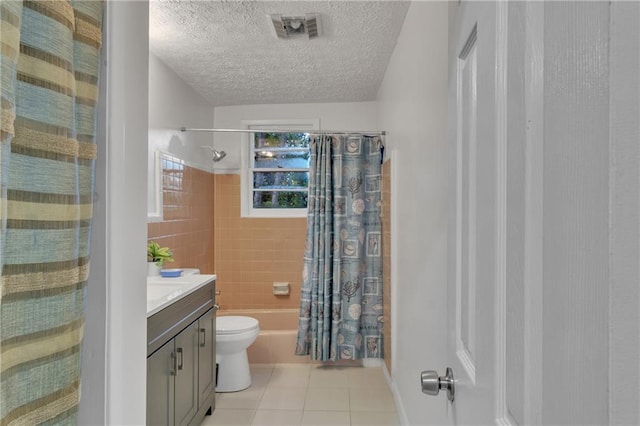 bathroom featuring visible vents, toilet, tile patterned floors, a textured ceiling, and vanity