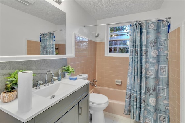 bathroom featuring a textured ceiling, toilet, vanity, tile walls, and shower / bath combo with shower curtain