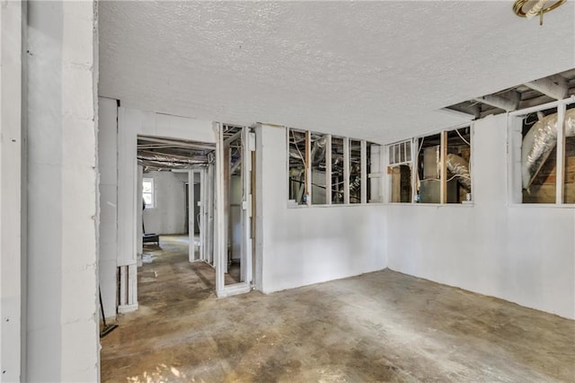 interior space featuring concrete floors and a textured ceiling