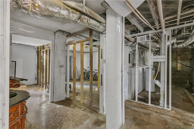 unfinished below grade area featuring water heater and visible vents