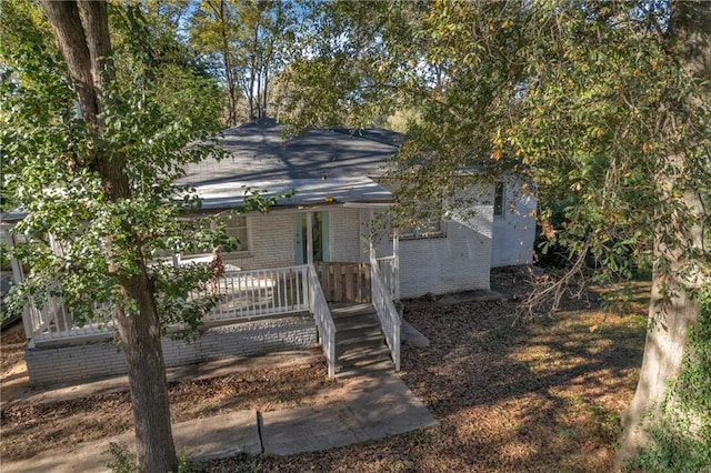 view of front facade with a porch and brick siding