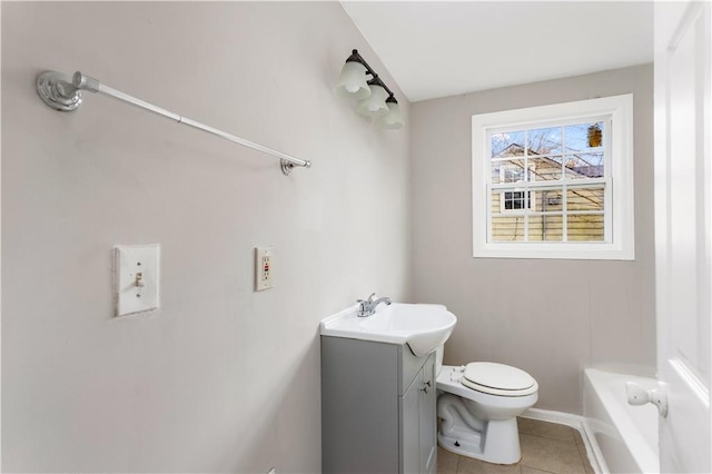 full bathroom featuring a bathing tub, toilet, vanity, and tile patterned flooring