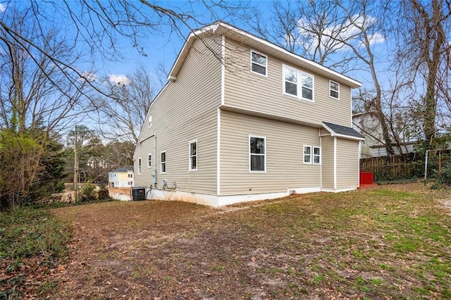 back of property with crawl space, central AC unit, and fence