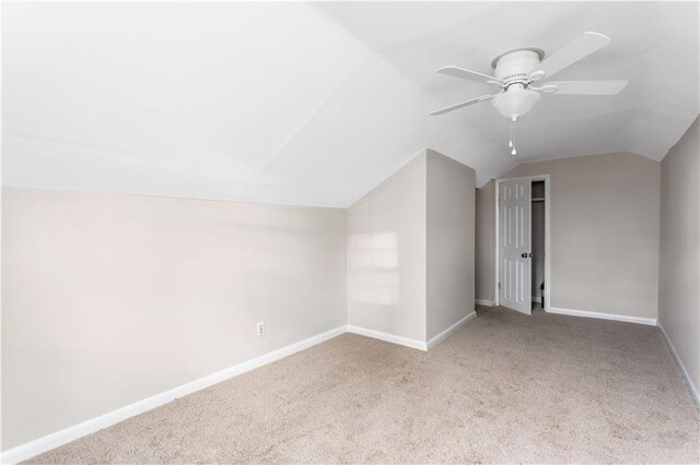 additional living space with baseboards, carpet floors, lofted ceiling, and ceiling fan