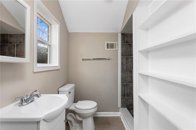 bathroom featuring visible vents, toilet, a tile shower, tile patterned floors, and vanity