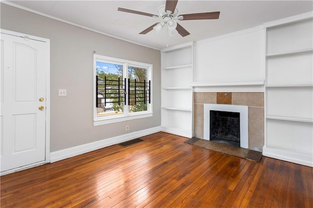 unfurnished living room featuring visible vents, baseboards, a fireplace, and hardwood / wood-style flooring