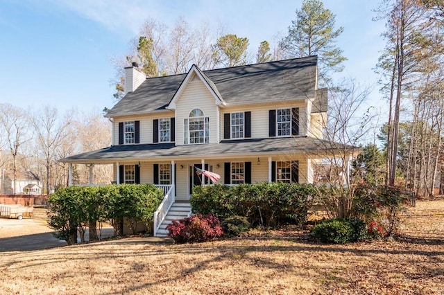 view of front of property featuring a porch, a chimney, and stairs