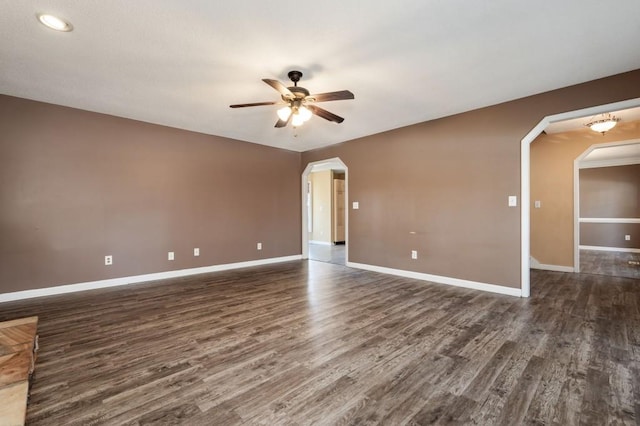 spare room with ceiling fan and dark hardwood / wood-style floors