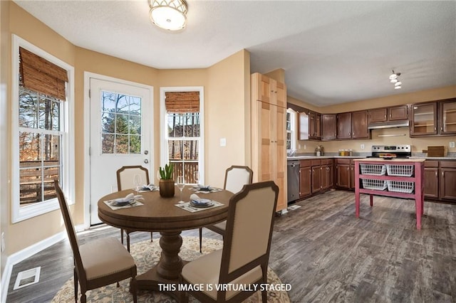 dining room featuring dark wood finished floors, visible vents, and baseboards