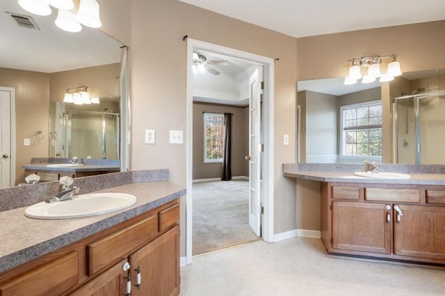 bathroom with vanity and a shower with door