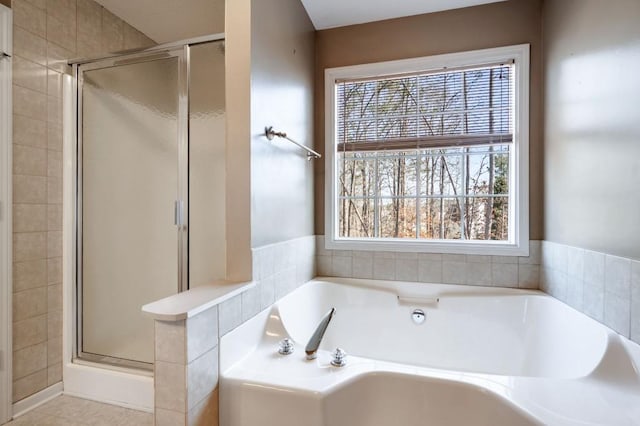 full bathroom featuring a stall shower and a bath