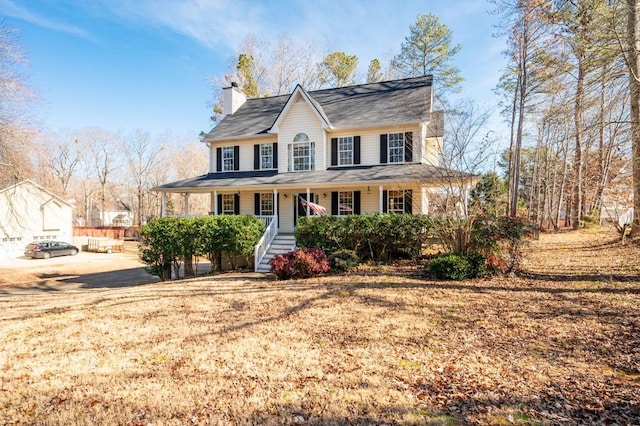 view of front facade with covered porch and a front yard