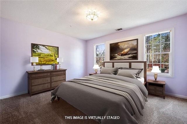 carpeted bedroom with multiple windows, visible vents, and baseboards