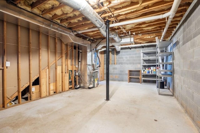 unfinished basement featuring heating unit