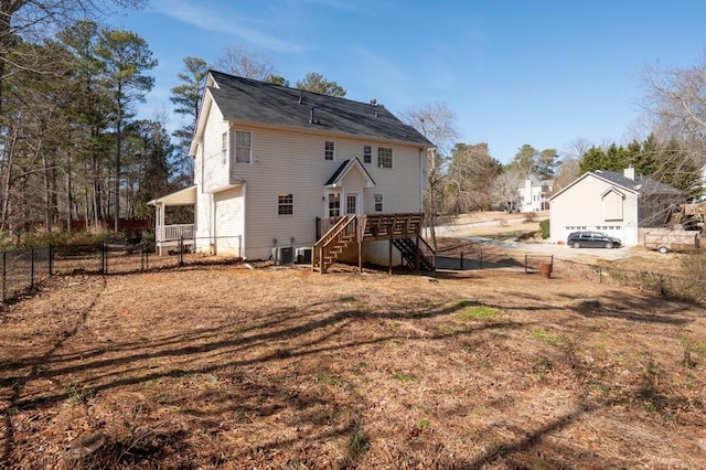 rear view of house with stairs, central AC unit, and fence