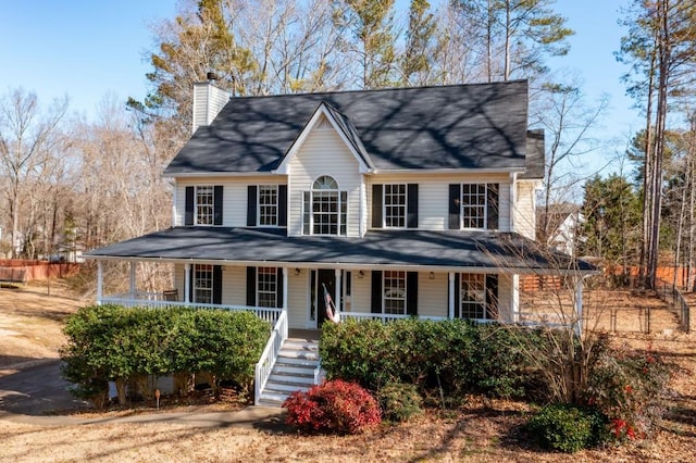 view of front of house with covered porch, a chimney, and stairs