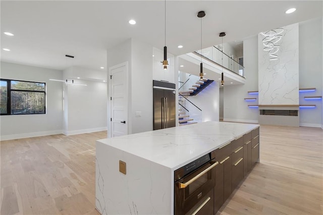 1678 Thomas Dr, Hoschton, GA 30548 - kitchen with high end fridge, modern cabinets, wall oven, light wood-style floors, and open floor plan