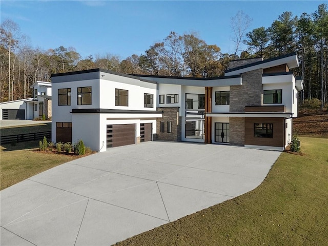 1678 Thomas Dr, Hoschton, GA 30548 - contemporary house with stone siding, driveway, stucco siding, and an attached garage