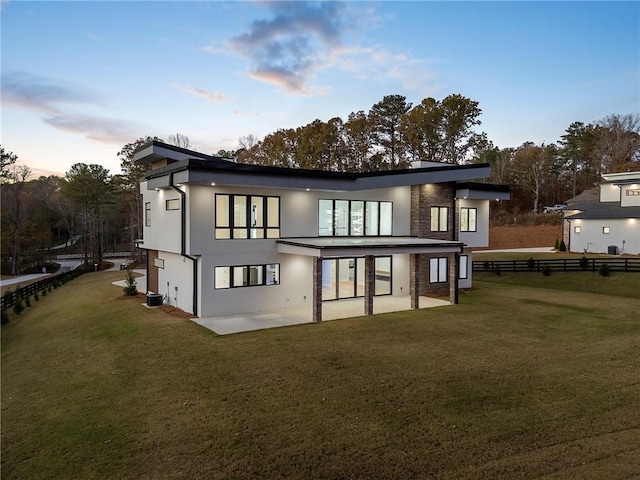 1678 Thomas Dr, Hoschton, GA 30548 - back of house with a patio area, stucco siding, and stone siding