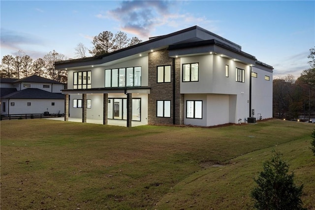 1678 Thomas Dr, Hoschton, GA 30548 - back of property featuring central AC and stucco siding