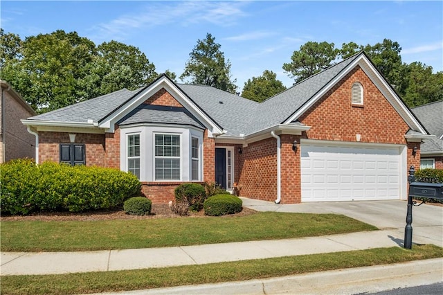 view of front of home with a garage and a front lawn