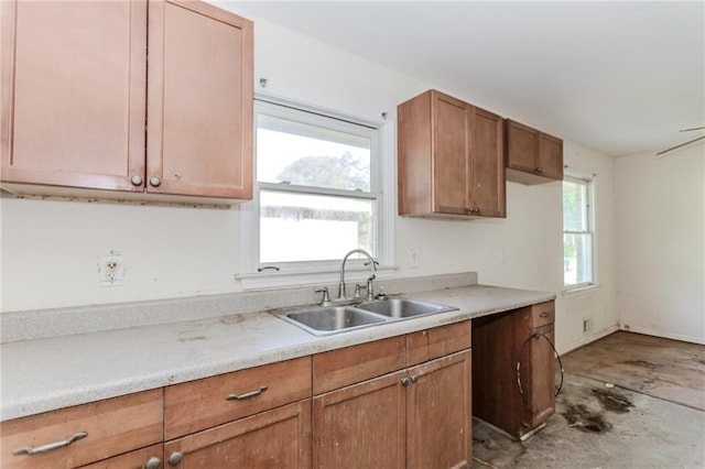 1167 Sanders Dr, Morrow, GA 30260 - kitchen featuring a sink, light countertops, concrete flooring, and brown cabinetry