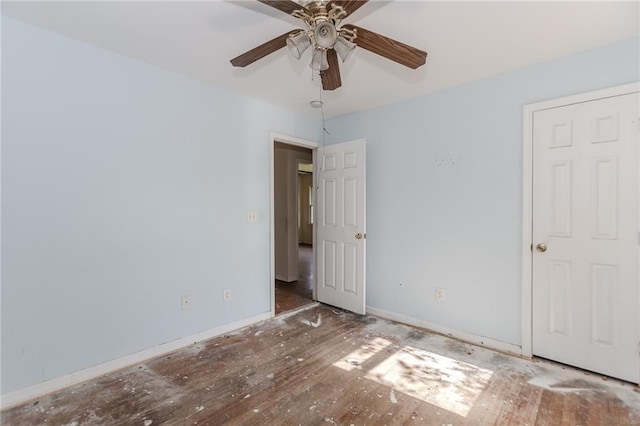 1167 Sanders Dr, Morrow, GA 30260 - unfurnished bedroom featuring baseboards, wood finished floors, and ceiling fan