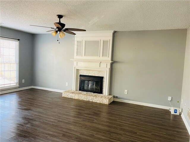 unfurnished living room featuring a textured ceiling, hardwood / wood-style flooring, and ceiling fan