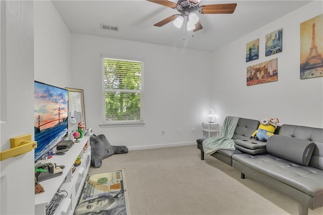 living area with carpet flooring, ceiling fan, and baseboards