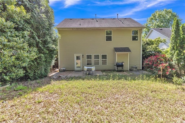 rear view of property with a patio and a yard