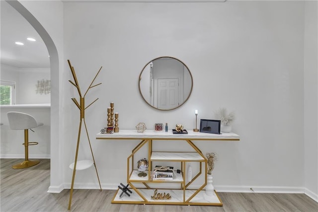 detailed view of wood finished floors, arched walkways, and baseboards