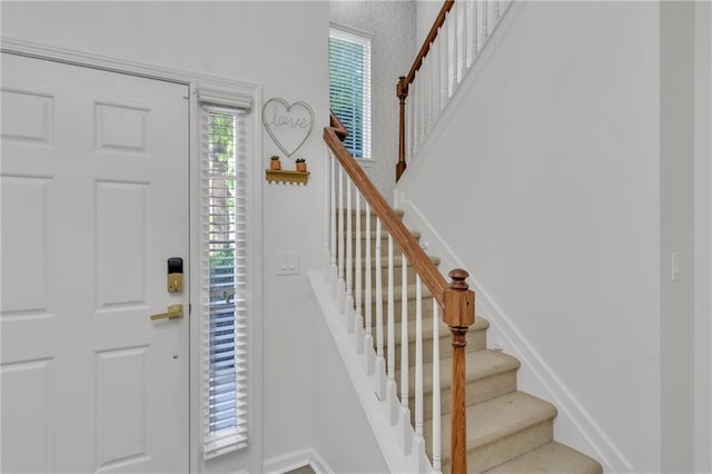entryway featuring stairway and baseboards