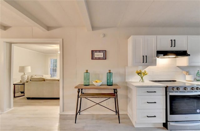 kitchen with white cabinets, decorative backsplash, stainless steel range with electric cooktop, and ventilation hood