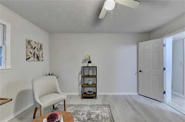 sitting room featuring wood finished floors, ceiling fan, and baseboards