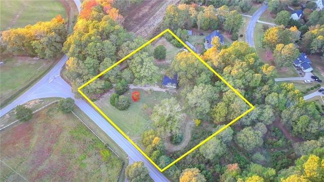 drone / aerial view with a wooded view