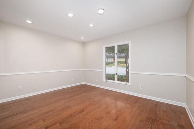 unfurnished room with wood-type flooring