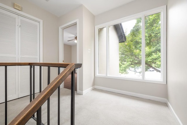 hall featuring light colored carpet