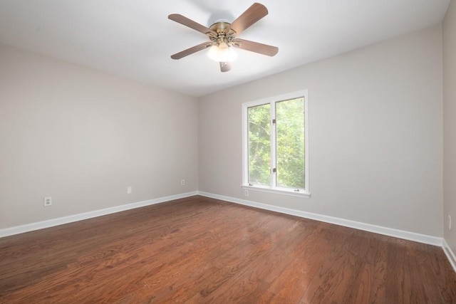 unfurnished room with ceiling fan and dark hardwood / wood-style floors