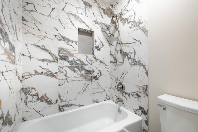 bathroom featuring washtub / shower combination and toilet