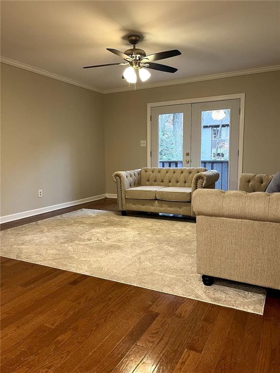 unfurnished living room with french doors, ceiling fan, ornamental molding, and wood-type flooring