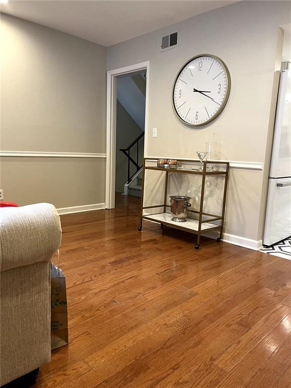 sitting room with hardwood / wood-style flooring