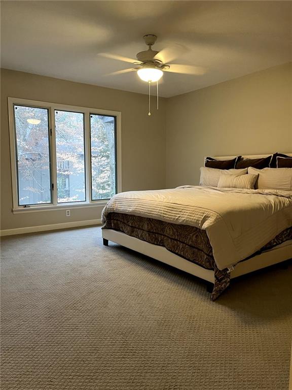 carpeted bedroom with ceiling fan