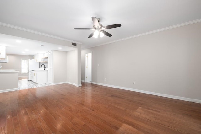 unfurnished living room featuring ceiling fan, crown molding, and wood-type flooring