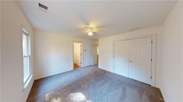 unfurnished bedroom featuring carpet flooring, a closet, and ceiling fan