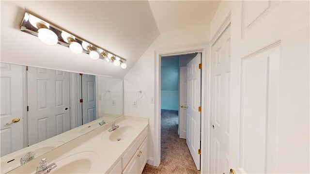 bathroom with vanity and vaulted ceiling