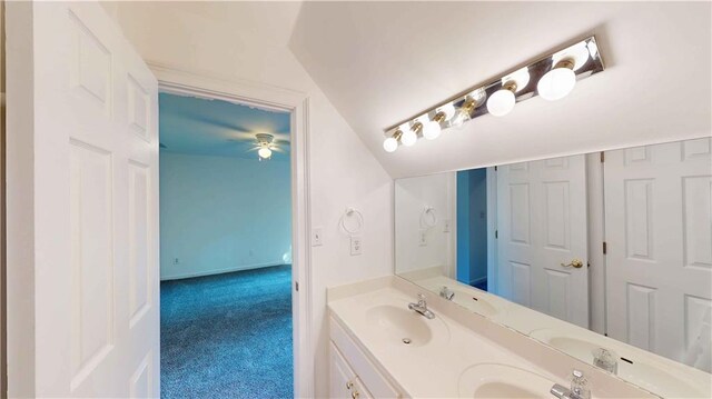 bathroom featuring vanity, ceiling fan, and lofted ceiling