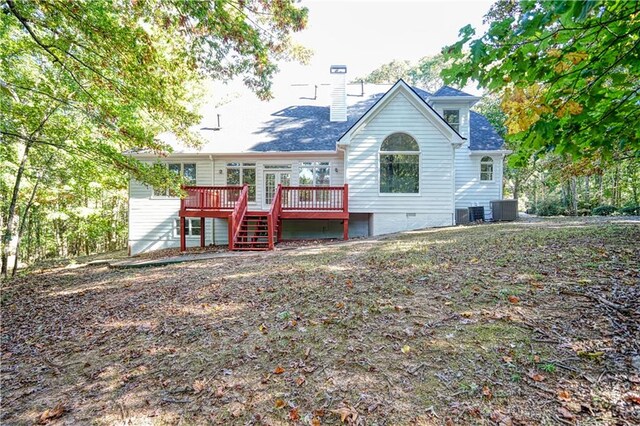 rear view of property with a wooden deck and central AC unit