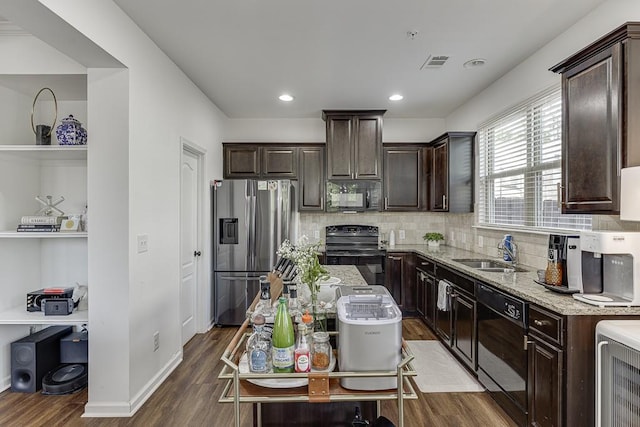 kitchen with black appliances, a sink, dark brown cabinets, wood finished floors, and recessed lighting