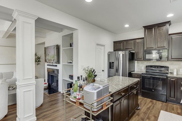 kitchen featuring black appliances, ornate columns, dark wood finished floors, dark brown cabinets, and light stone counters