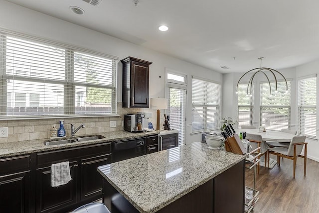 kitchen featuring dishwasher, a sink, healthy amount of natural light, a kitchen island, and recessed lighting